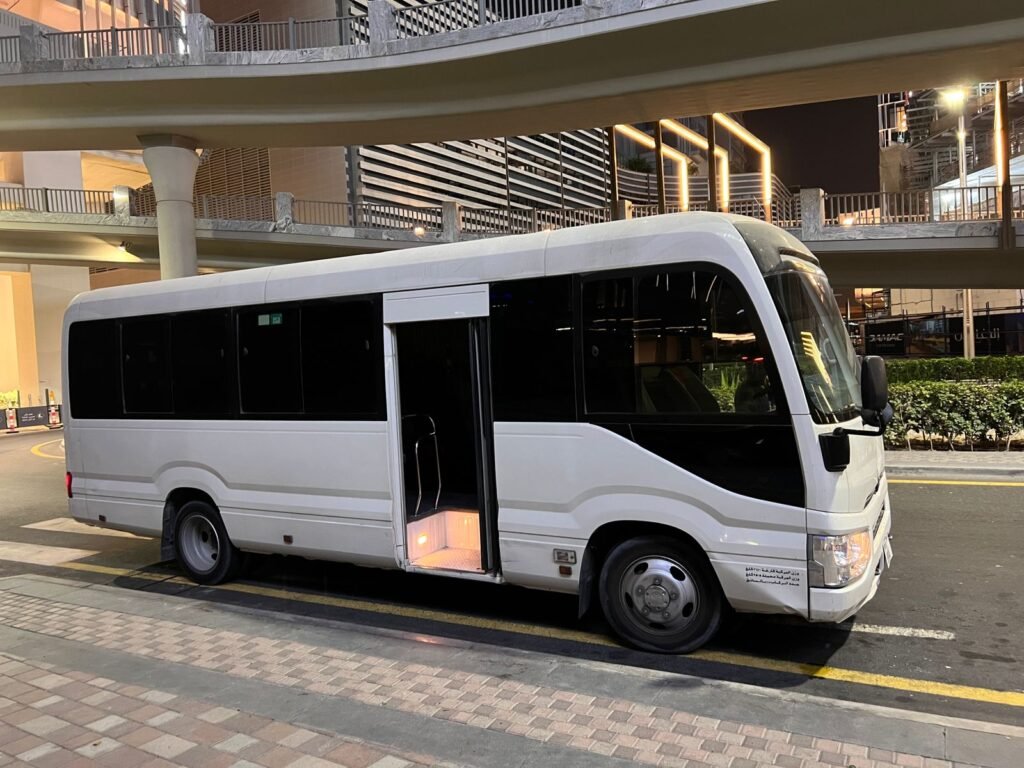 A 22-seater Toyota Coaster bus for rent in Dubai, offering comfortable seating and a reliable transportation solution for small groups.