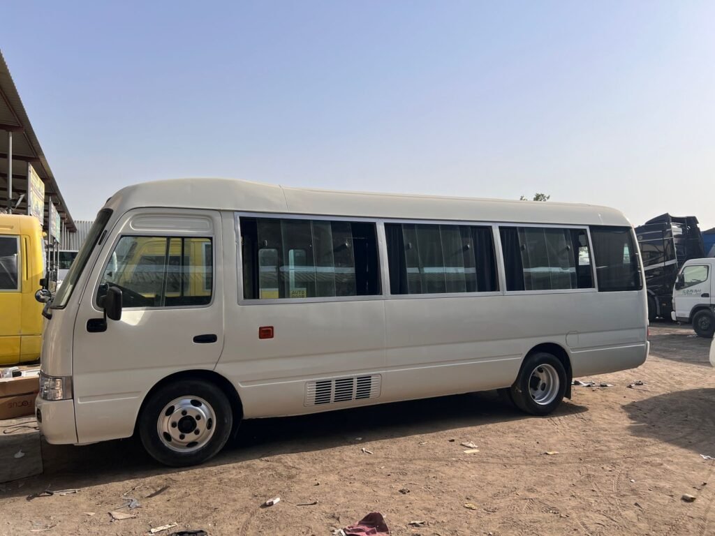 A 30-seater Coaster bus for rent in Dubai, offering spacious seating and efficient group transportation for various needs.