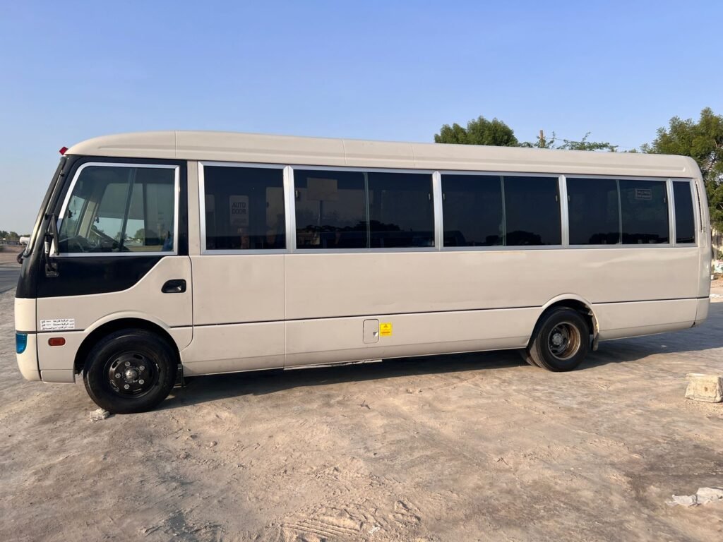 A 32-seater Toyota Coaster bus available for rent in Dubai, offering spacious seating and comfortable travel for larger groups.