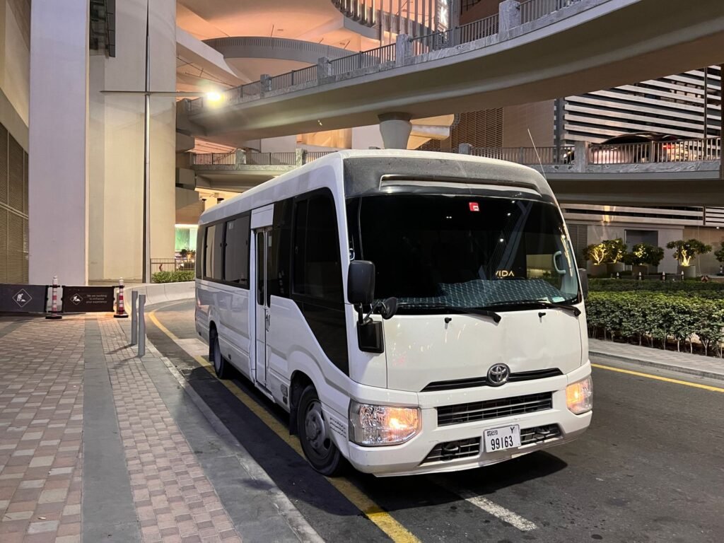 A Toyota bus available for rent in Dubai, designed for group travel with spacious seating and reliable features.