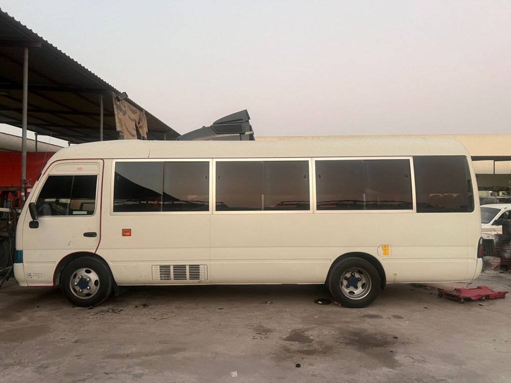 A Toyota Coaster bus for rental in Dubai, ideal for group travel with spacious seating and modern amenities.